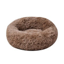 Soft round pet bed with a luxurious faux fur exterior providing comfort for pets.