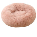 Soft round pet bed in pink faux fur, designed for ultimate comfort and coziness for pets.