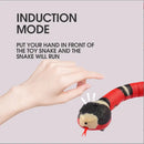 Hand activating induction mode on smart moving snake toy for cats, showcasing its interactive feature.
